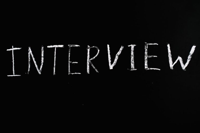 Chalkboard writing of 'Interview' on a sleek black background, perfect for business themes.