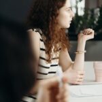 Focused businesswoman attentively listening during a meeting in a modern office.